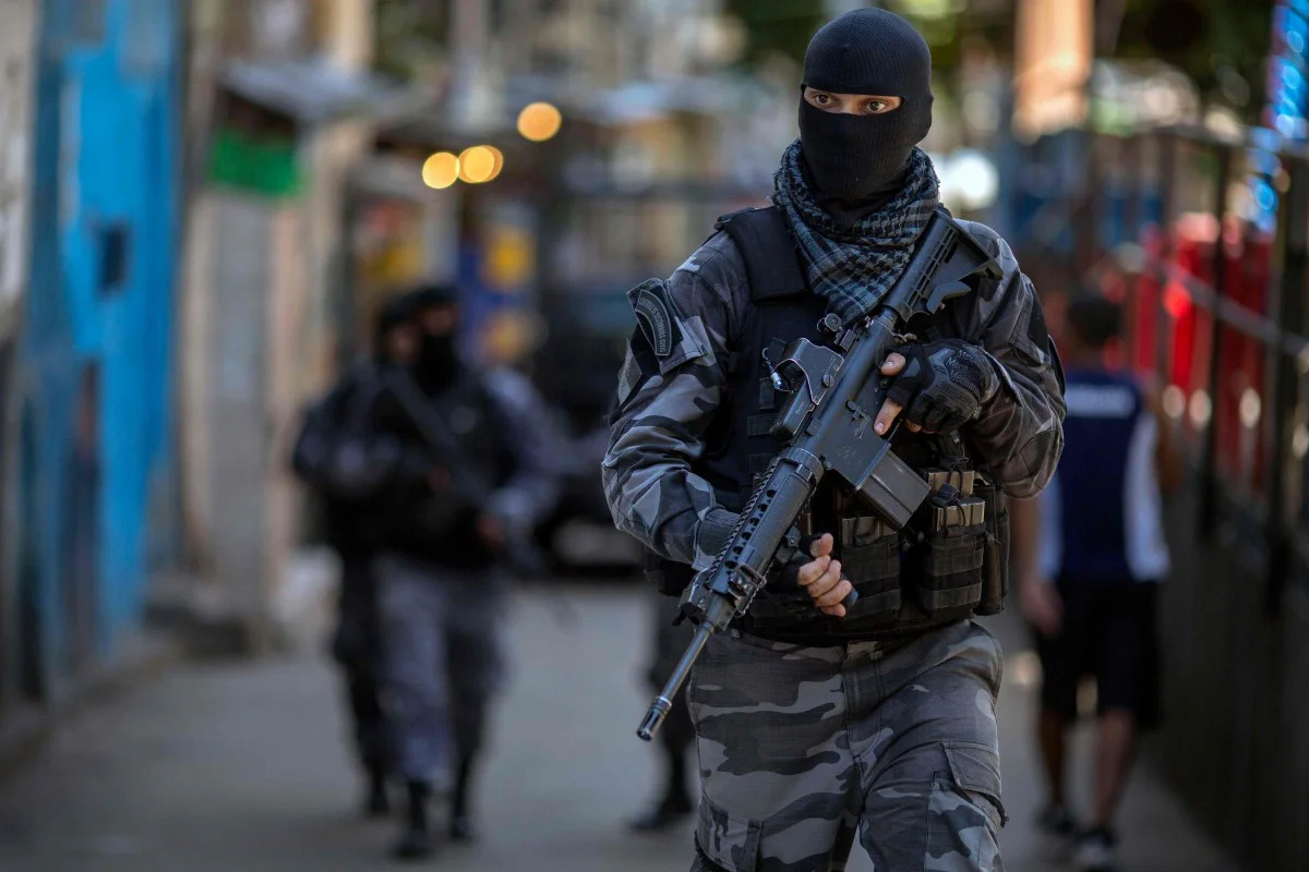 Members of the Brazilian Military Police special unit Choque, patrol during an operation in the Rocinha favela in Rio de Janeiro, Brazil. Photo: AFP

