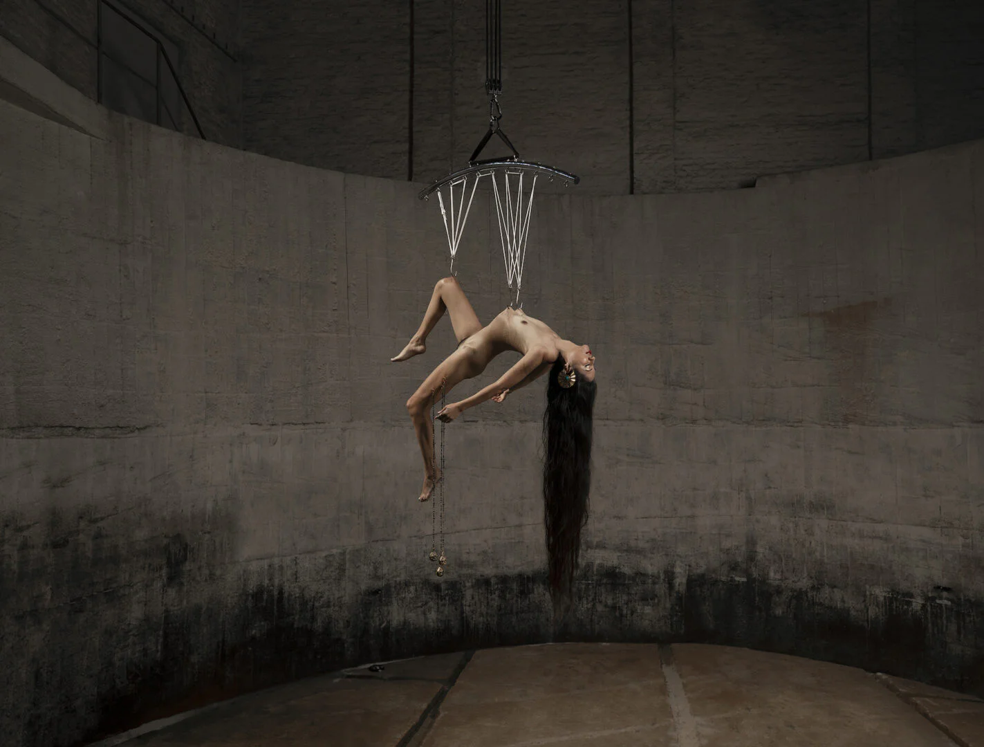 GØNEJA ✷ 7 Luna Duran: Venus Conjunct Chiron, (2023), inkjet print,100 x 130 cm | The extreme ritual performance of the Bolivian artist Luna Duran, embodying the myth of the wounded centaur conjunct with Venus in the night sky through a full body hook suspension and hand-made jewellery pierced onto her thigh.